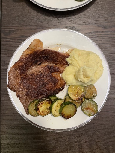 ribeye steak with mashed potatoes and zucchini